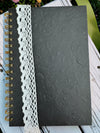 Embossed/textured black spiral-bound hard cover journal/notebook